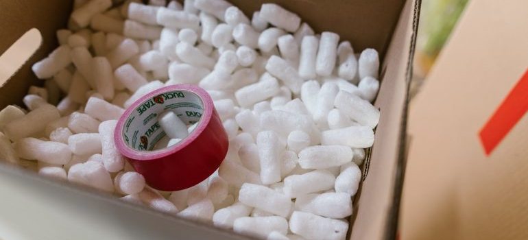 packing peanuts in a cardboard box with the tape