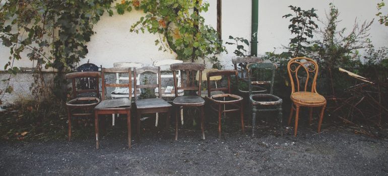 Old chairs in front of a hosue