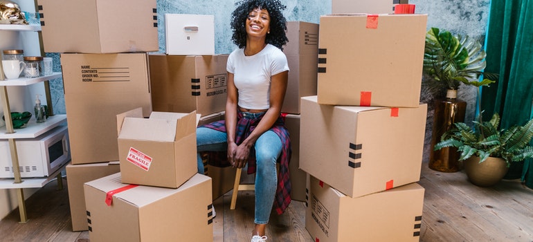 Woman surrounded by boxes that will be stored in residential onsite storage containers
