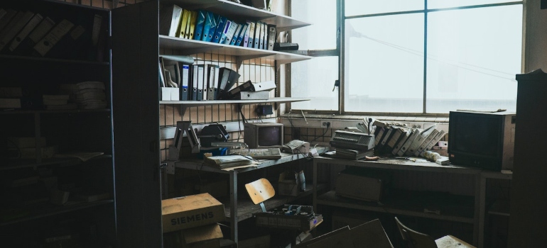 A cluttered office- perfect for renting onsite storage units