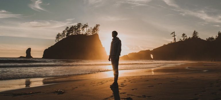 A man at the beach thinking about the best DMV cities for real estate investment