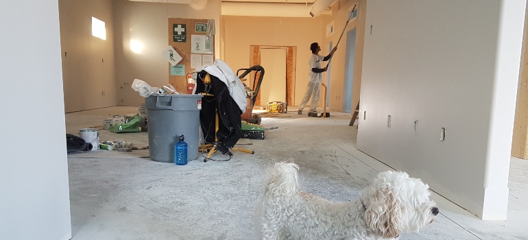 a man renovating a house after renting onsite storage for flooded basement