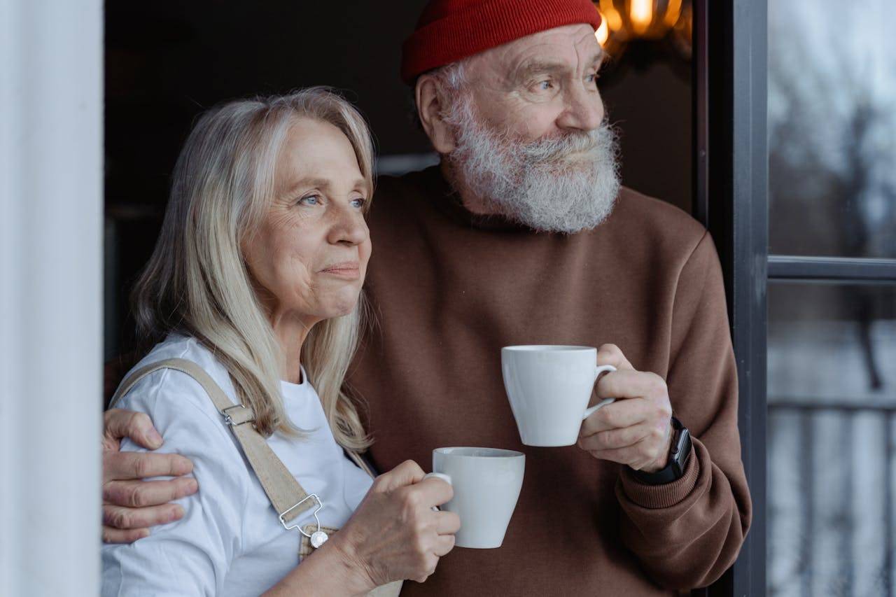 An elderly couple enjoying coffee